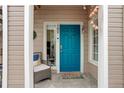 Charming entry with a vibrant blue door, potted plants, and a welcoming atmosphere at 8415 Pebble Creek Way # 102, Highlands Ranch, CO 80126