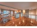 Inviting living room featuring hardwood floors flowing into an updated kitchen with stainless steel appliances at 889 Douglas Dr, Denver, CO 80221