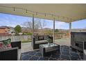 Relaxing covered patio with comfortable seating, string lights, and a scenic view at 4713 S Robb St, Littleton, CO 80127
