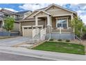 Attractive home showcasing a cozy front porch with stone accents and a well-manicured lawn at 22820 E Chenango Ave, Aurora, CO 80015