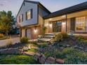 Well-maintained two-story home with manicured landscaping, brick accents, and covered front porch at 7668 S Locust St, Centennial, CO 80112