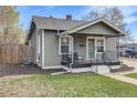 Charming home featuring stylish siding, a cozy front porch, and well-maintained landscaping at 4478 S Acoma St, Englewood, CO 80110