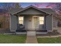 Charming home with inviting front porch, landscaped yard, and attractive exterior paint at 4478 S Acoma St, Englewood, CO 80110