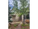 Charming home featuring a stone facade, well-maintained landscaping, and a cozy bench near the entrance at 31190 Cinnamonwood, Evergreen, CO 80439