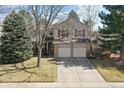 Charming two-story home with red shutters, a two-car garage and a manicured front yard at 270 S Locust St, Denver, CO 80224