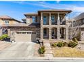 Stunning two-story home showcasing stone accents, a tile roof, and a covered front porch at 493 Pine Flower Ct, Highlands Ranch, CO 80126