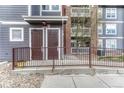 Close-up of building entrance with brick detail and handicap ramp accessibility to the condo units at 14333 E 1St Dr # 307, Aurora, CO 80011