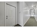 Hallway leading to unit 307, showing neutral carpeting and wall color; a secure and private entry at 14333 E 1St Dr # 307, Aurora, CO 80011