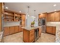 Gourmet kitchen with a large island, stainless steel appliances, and ample cabinet storage at 2290 S Braun Way, Lakewood, CO 80228