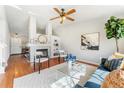 Spacious living room featuring a fireplace, built-in shelving, ceiling fan, and a comfortable blue sofa at 5207 S Jericho Way, Centennial, CO 80015