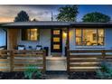 Inviting front porch with modern wooden fence and landscaping at 4995 E Atlantic Pl, Denver, CO 80222