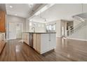 Open concept kitchen with an island and stainless steel appliances, flowing into a spacious living area at 1622 W 67Th Ave, Denver, CO 80221