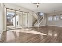 Bright and airy living room with sliding glass doors, hardwood floors, and a view of the backyard at 1622 W 67Th Ave, Denver, CO 80221