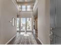 Bright two-story foyer with hardwood floors, large windows, and modern finishes at 18875 W 93Rd Ave, Arvada, CO 80007