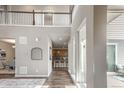 Spacious foyer featuring wood floors, tall ceilings, and views to the kitchen at 18875 W 93Rd Ave, Arvada, CO 80007