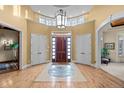 Welcoming foyer with hardwood floors, arched doorways, and ample natural light at 5 Redhawk Run, Cherry Hills Village, CO 80113