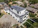 Aerial view of a modern home featuring a rooftop deck and beautifully landscaped yard in quiet neighborhood at 1541 Glencoe St, Denver, CO 80220