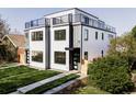 Contemporary home with rooftop deck, modern siding, inviting lawn, and stylish black framed windows at 1541 Glencoe St, Denver, CO 80220