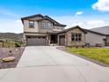 Charming two-story home with stone accents, gray garage, and a spacious driveway at 3187 S Quaker St, Morrison, CO 80465