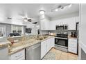 Modern kitchen boasts stainless appliances, granite counters, and an open design at 1303 S Danube Way # 104, Aurora, CO 80017
