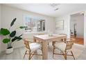 Cozy dining room with contemporary decor, wood table and chairs, and a large window at 2482 Otis Ct, Edgewater, CO 80214