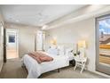 Bright main bedroom with large window, plush carpet, and en-suite bathroom at 1415 Irving St, Denver, CO 80204