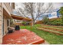 Backyard area featuring a pergola covered deck, a grill, and terraced garden beds at 6057 S Pierson St, Littleton, CO 80127