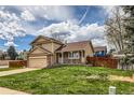 Two-story home with a charming front porch and manicured lawn, perfect for curb appeal at 6057 S Pierson St, Littleton, CO 80127