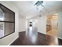 Bright dining room with dark hardwood floors and kitchen access at 12093 W Cross Dr # 206, Littleton, CO 80127