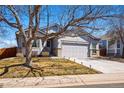 Charming single-Gathering home with a well-manicured lawn, mature trees, and a two-car garage and a neutral color scheme at 18315 E Amherst Dr, Aurora, CO 80013