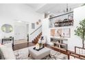 Bright living room features high ceilings, modern furnishings, and a staircase at 18213 E Saskatoon Pl, Parker, CO 80134