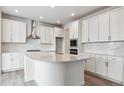 Modern kitchen features white cabinetry, stainless steel appliances, and a spacious center island at 39152 Clymer St, Elizabeth, CO 80107