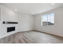 Inviting living room features a fireplace, wood mantle and hardwood floors, perfect for relaxation at 39152 Clymer St, Elizabeth, CO 80107