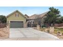 Charming home with stone accents, lush lawn, and a welcoming entrance in a serene, landscaped setting at 7178 Galaxy Ct, Castle Rock, CO 80108