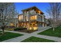 Modern home with stone accents, expansive windows, and manicured lawn at 2539 E 5Th Ave, Denver, CO 80206
