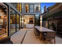 Outdoor patio features dining area, and seamless transition to living room with large sliding doors at 2539 E 5Th Ave, Denver, CO 80206