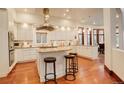 Spacious kitchen with white cabinets, stainless steel hood, hardwood floors and granite countertops at 2931 S Cook St, Denver, CO 80210