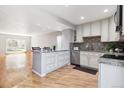 Open-concept kitchen with large island, stainless steel appliances, and ample cabinet space at 6400 E Mississippi Ave, Denver, CO 80224