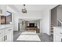 Open living space with hardwood floors, modern railing, and plenty of natural light at 7351 S Marion St, Centennial, CO 80122
