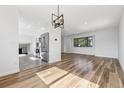 Bright living room with hardwood floors, recessed lighting, and an open concept to the kitchen at 7351 S Marion St, Centennial, CO 80122