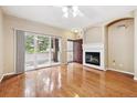 Bright living room with hardwood floors, fireplace, and sliding glass doors to a balcony at 7111 S Wenatchee Way # C, Aurora, CO 80016