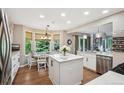 Bright kitchen features an island, stainless steel appliances, and a cozy breakfast nook at 775 Poppywood Dr, Highlands Ranch, CO 80126