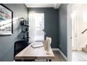 Cozy home office space with a wooden desk, a bookshelf and natural light filtering through the window at 3145 W 19Th Ave, Denver, CO 80204