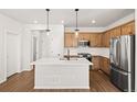 Modern kitchen featuring a large island, stainless steel appliances, and ample cabinet space at 8777 Whiteclover St, Littleton, CO 80125
