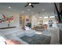 Comfortable living room with an L-shaped couch, an open kitchen, and an adjacent dining area at 10018 E 62Nd Ave, Denver, CO 80238