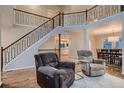 Inviting living room showcasing an open floorplan with hardwood floors and a modern staircase at 13076 Marion Dr, Thornton, CO 80241