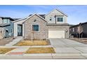 Charming two-story home featuring a stone facade, two-car garage and inviting curb appeal at 6400 Barnstead Dr, Castle Pines, CO 80108