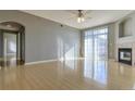 Bright living room featuring a ceiling fan, fireplace, and sliding glass doors at 7440 S Blackhawk St # 12-204, Englewood, CO 80112