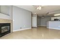 Comfortable living room with a fireplace and a view of the adjacent kitchen area at 7440 S Blackhawk St # 12-204, Englewood, CO 80112