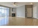 Open-concept living room with fireplace, ceiling fan, and lots of natural light at 7440 S Blackhawk St # 12-204, Englewood, CO 80112